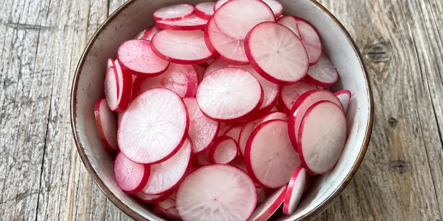 Thinly sliced red radishes for quick refrigerator pickled vegetables