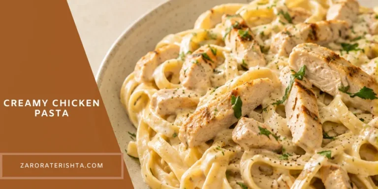 Creamy chicken pasta served in a bowl with tender chicken pieces coated in a rich creamy sauce on a warm neutral kitchen table.