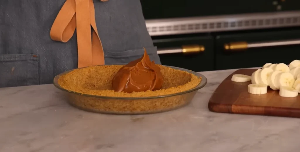 Dulce de leche spread over a graham cracker crust for Banoffee Pie