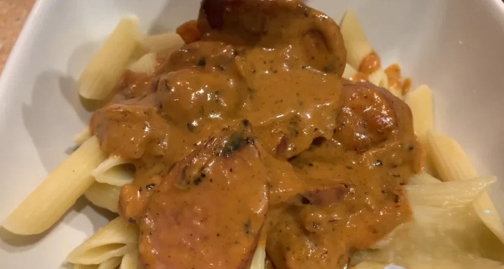 Creamy Cajun sausage pasta with penne and sliced smoked sausage