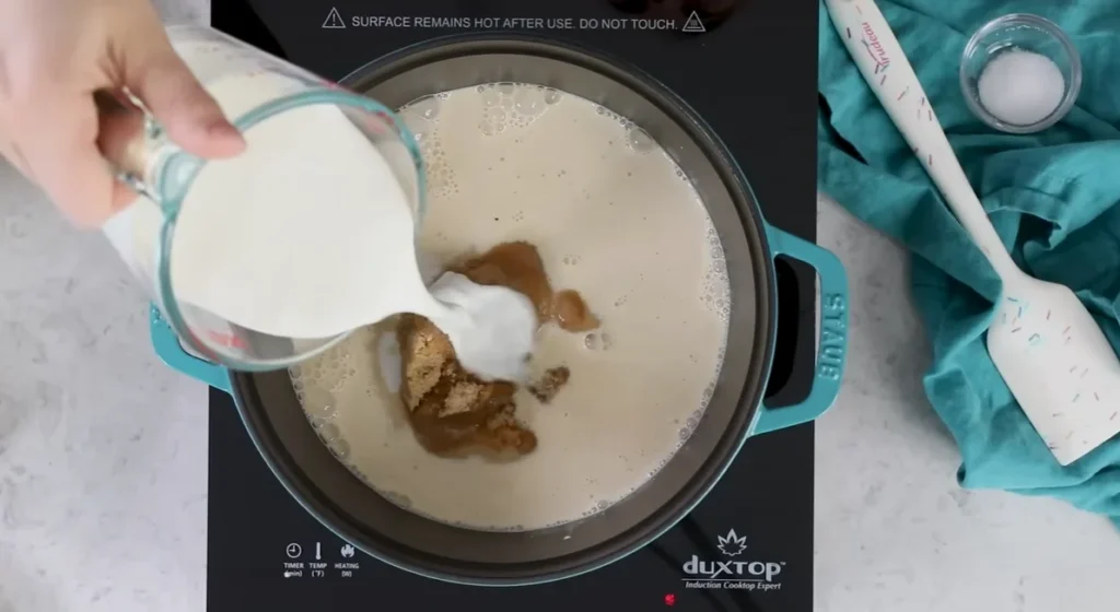 Heavy cream added gradually to the caramel mixture while stirring