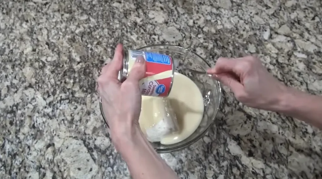 Sweetened condensed milk added to cream cheese mixture for cherry cream cheese pie