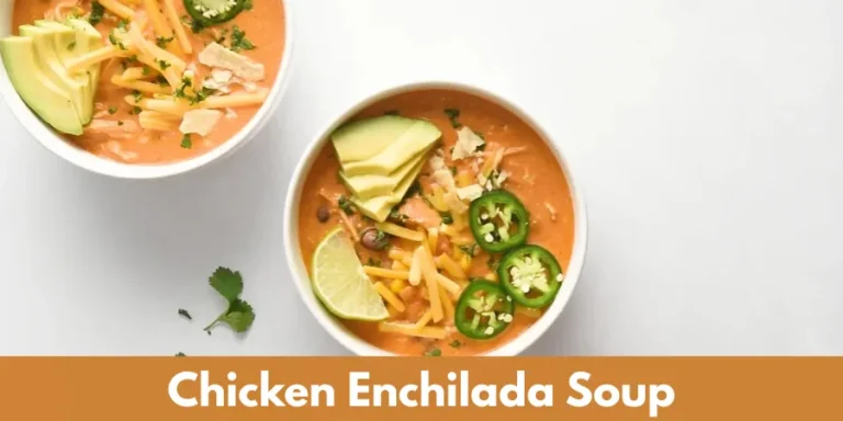 Creamy chicken enchilada soup topped with avocado, shredded cheese, jalapeños, cilantro and lime