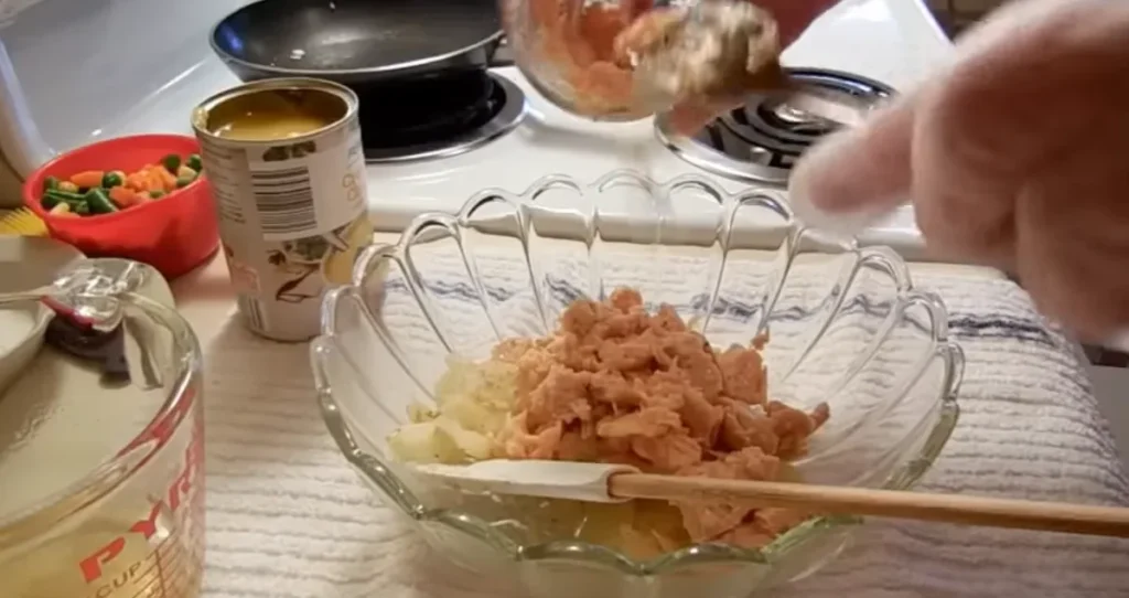 Cooked chicken added to the chicken pot pie casserole filling