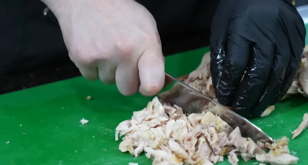 Shredded cooked chicken being prepared for creamy chicken tortilla soup