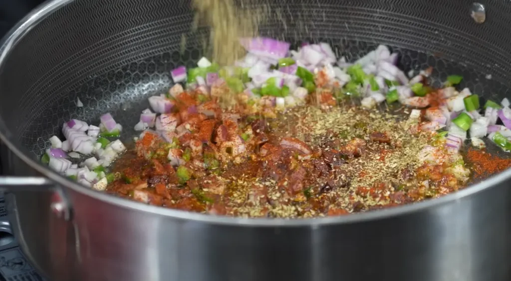 Taco seasoning and spices added to sautéed vegetables for tortilla soup
