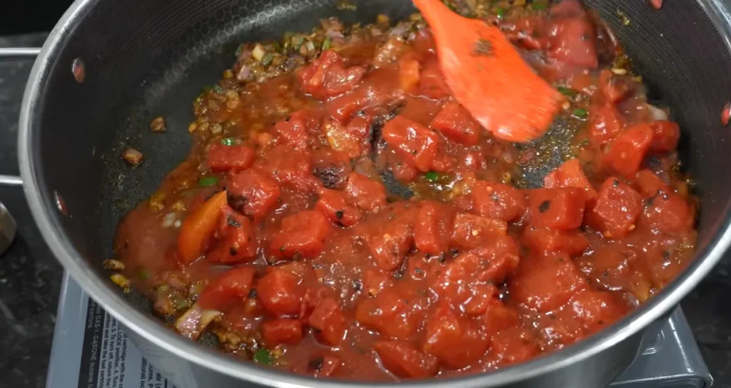 Fire-roasted tomatoes added to the seasoned soup base