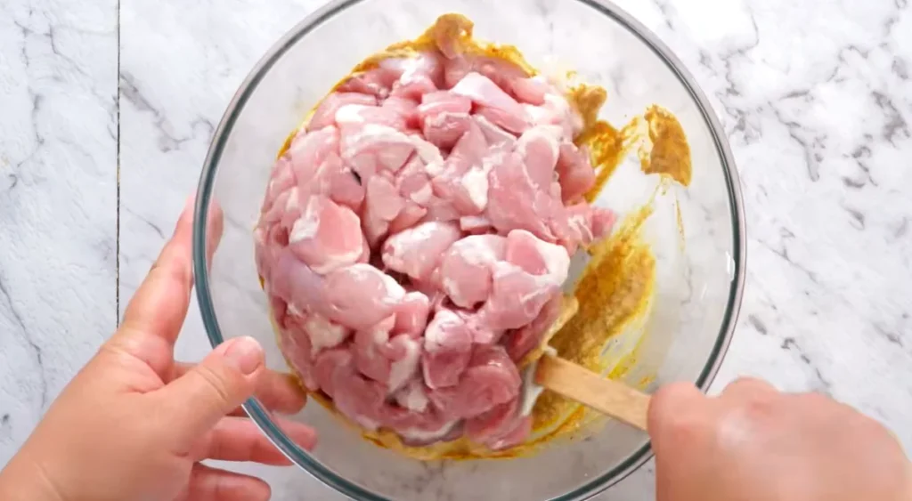 Boneless chicken pieces coated in yogurt and spices for butter chicken marinade
