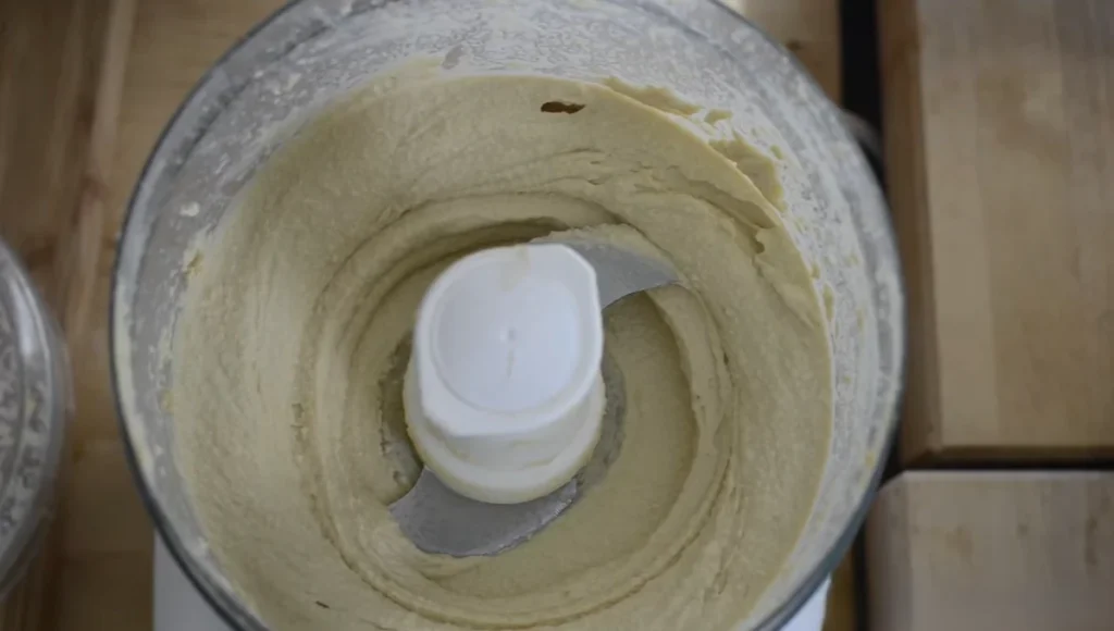 Smooth and creamy homemade hummus after blending in a food processor.