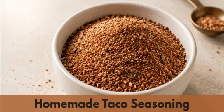 A small bowl of homemade taco seasoning on a clean neutral kitchen surface, showing the finished spice blend in a simple food presentation.