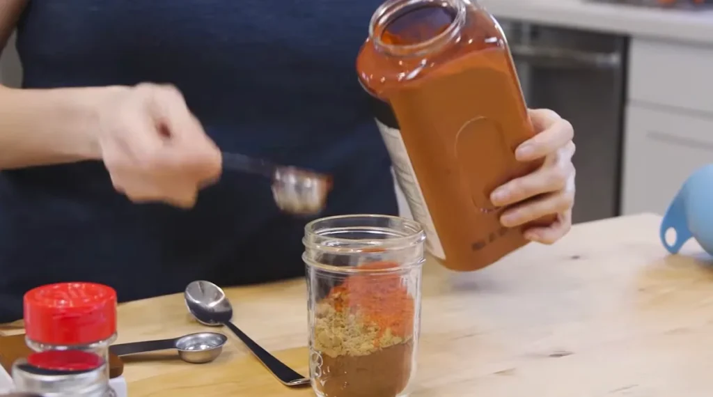 Paprika being added to homemade taco seasoning blend