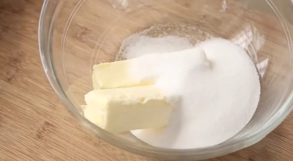 Cold butter and sugar in a mixing bowl