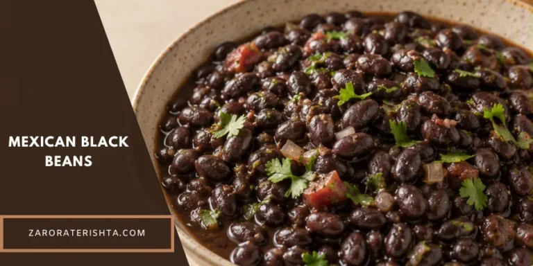 A rustic ceramic bowl filled with homemade Mexican black beans on a warm wooden table, with a serving spoon and neutral linen nearby in a softly blurred home kitchen.