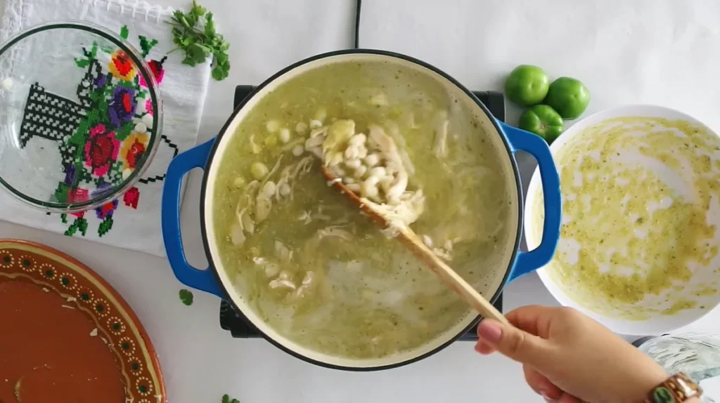 Chicken Pozole Verde simmering with shredded chicken and white hominy