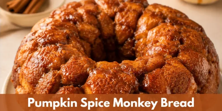 A complete golden-brown pull-apart monkey bread with caramelized edges on a simple serving plate, photographed in a warm home-baking setting.