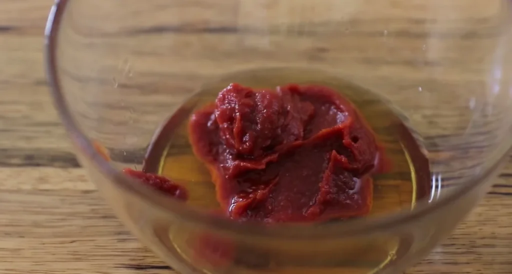 Sesame chicken sauce ingredients mixed in a glass bowl