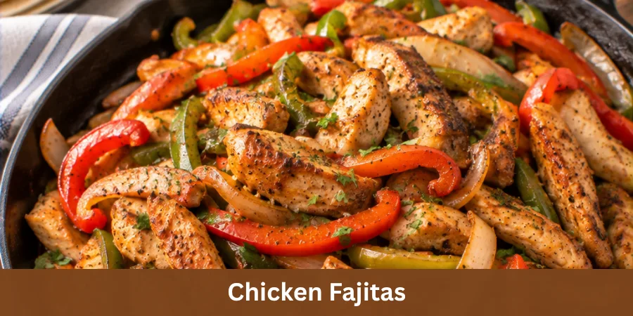 A serving of Chicken Fajitas with tender browned chicken, sautéed peppers and onions in a simple dish on a neutral table, photographed from an elevated three-quarter angle for a polished homemade recipe presentation.