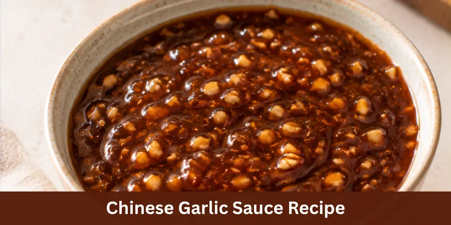 A bowl of homemade Chinese Garlic Sauce with a smooth glossy surface, presented as a finished sauce on a simple serving surface in natural light.