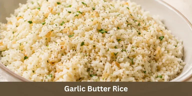 A bowl of Garlic Butter Rice with fluffy cooked grains and subtle garlic pieces, photographed as a finished homemade side dish in a simple table setting.