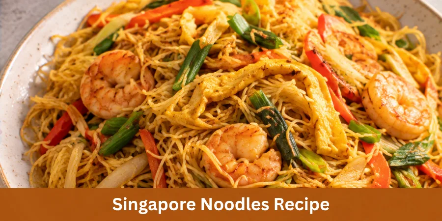 A bowl of freshly prepared Singapore noodles with rice noodles and vegetables, shown as a finished homemade dish.