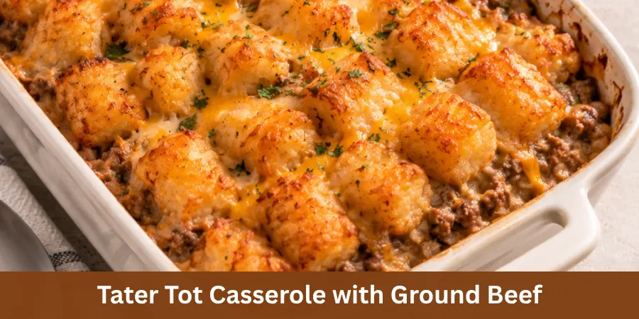 A finished Tater Tot Casserole with Ground Beef in a baking dish viewed from a clean three-quarter angle, with a golden tater tot topping and a simple serving utensil nearby. The image presents the complete casserole as a dinner recipe.