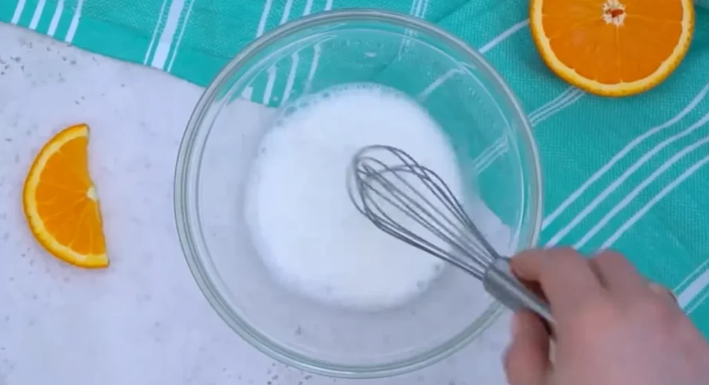 Whisking cornstarch and cold water in a glass bowl until smooth