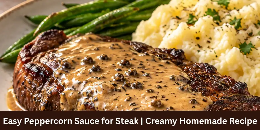 A cooked steak plated with creamy peppercorn sauce on a clean neutral serving surface, with naturally visible peppercorns in the sauce and a simple refined presentation.